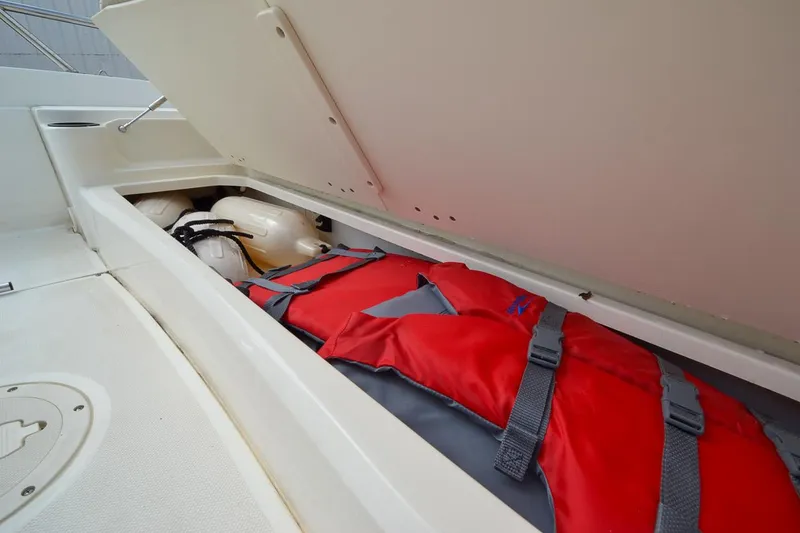 Slide: The Image of 2019 Boston Whaler 180 Dauntless storage compartment with life jackets. - 21