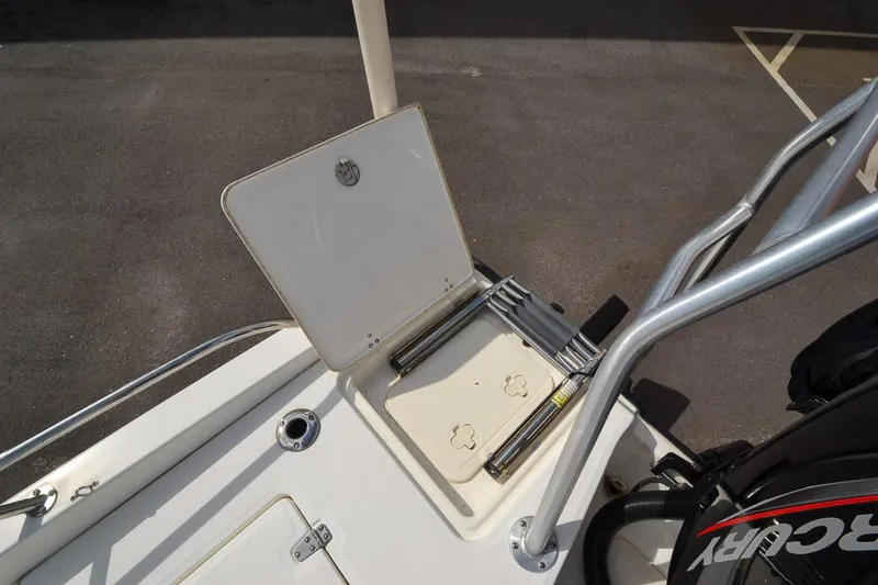 Slide: The Image of 2019 Boston Whaler 180 Dauntless boat with open storage compartment and Mercury engine. - 24