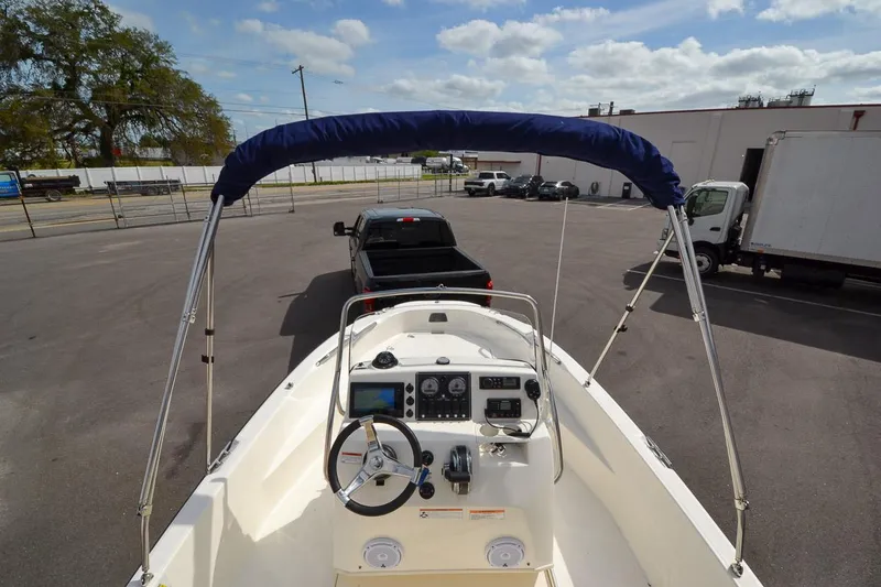 Slide: The Image of 2019 Boston Whaler 180 Dauntless boat with bimini top and console view. - 26