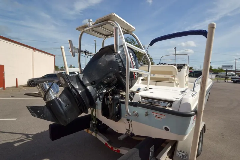 Slide: The Image of 2019 Boston Whaler 180 Dauntless boat with outboard motor in parking lot. - 3