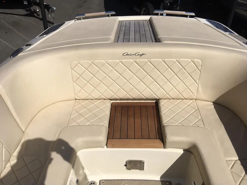 Slide: The Image of 2019 Chris-Craft Launch 27 boat with beige diamond-stitched seating and wooden accents. - 14