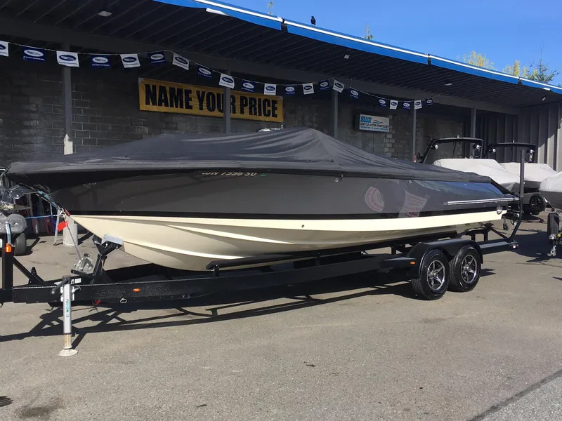 Slide: The Image of 2019 Chris-Craft Launch 27 boat on trailer, covered, displayed at dealership. - 2