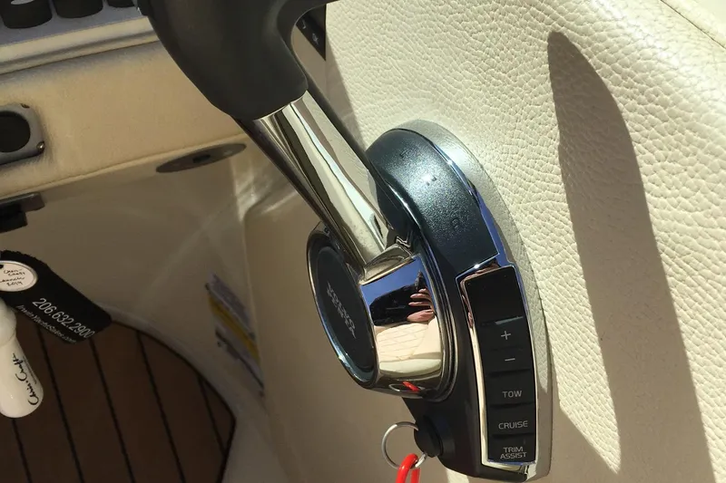Slide: The Image of 2019 Chris-Craft Launch 27 throttle control lever in a luxury boat interior. - 28