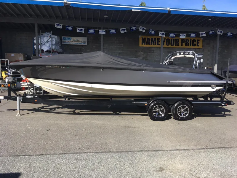 Slide: The Image of 2019 Chris-Craft Launch 27 boat on a trailer, covered and parked outdoors. - 33