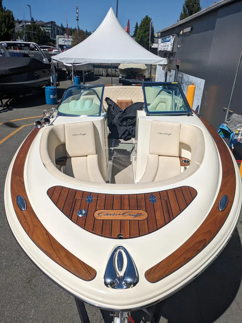 Slide: The Image of 2019 Chris-Craft Launch 27 boat with elegant wood detailing, docked outdoors. - 35