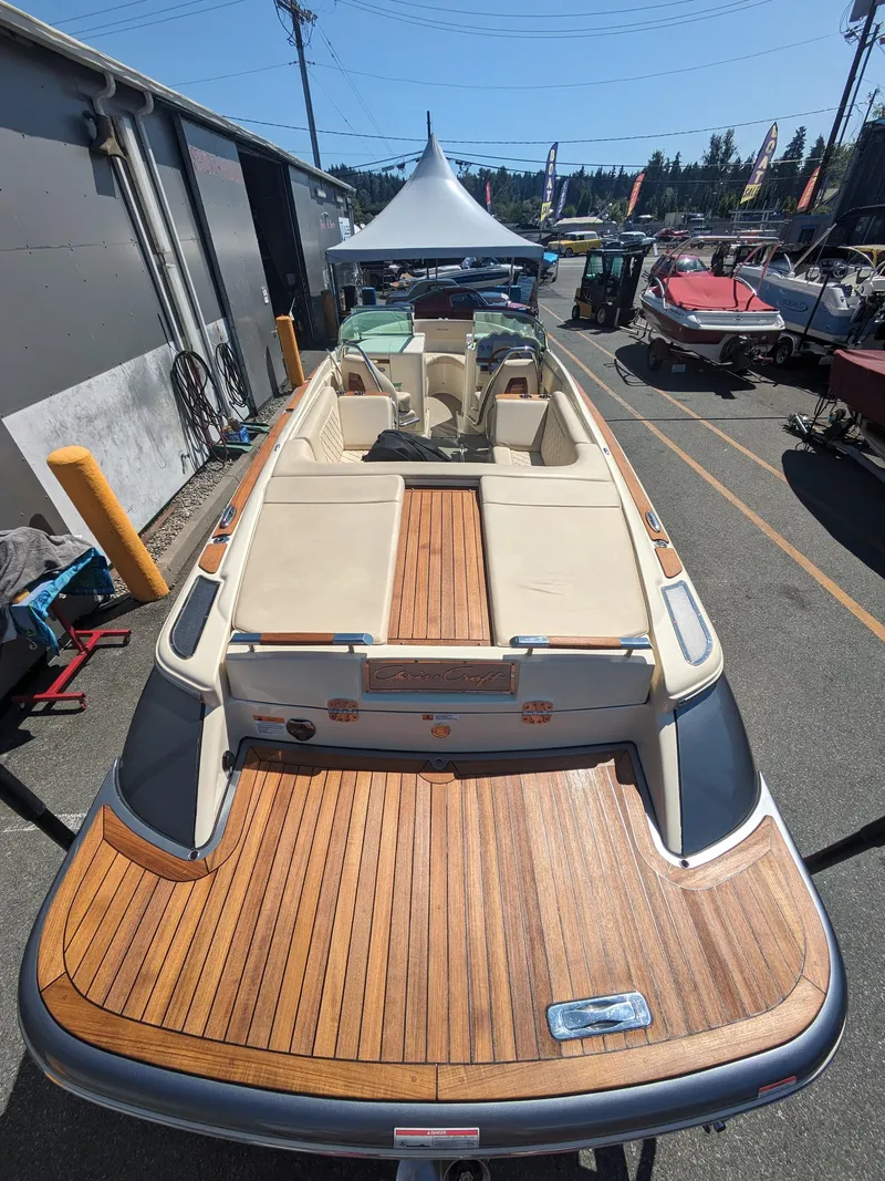 Slide: The Image of 2019 Chris-Craft Launch 27 boat with teak deck, displayed outdoors. - 5