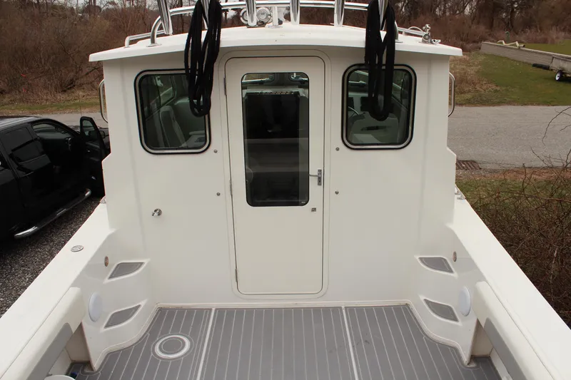 Slide: The Image of 2020 Parker 2520 XL Deep Vee Sport Cabin boat, rear view with cabin door and seating. - 10