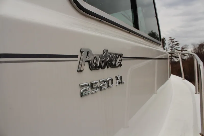 Slide: The Image of 2020 Parker 2520 XL Deep Vee Sport Cabin boat, side view with logo detail. - 18