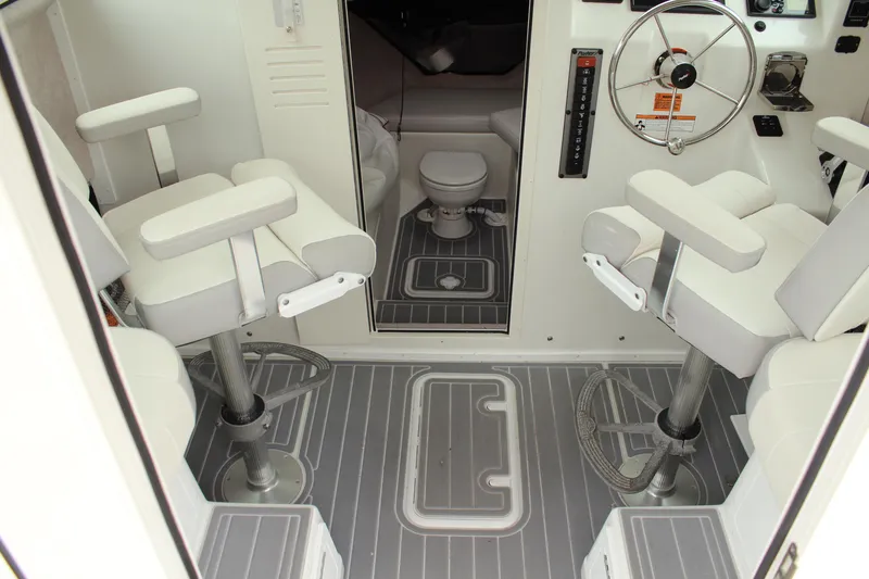 Slide: The Image of 2020 Parker 2520 XL Deep Vee Sport Cabin interior with seating and steering wheel. - 30