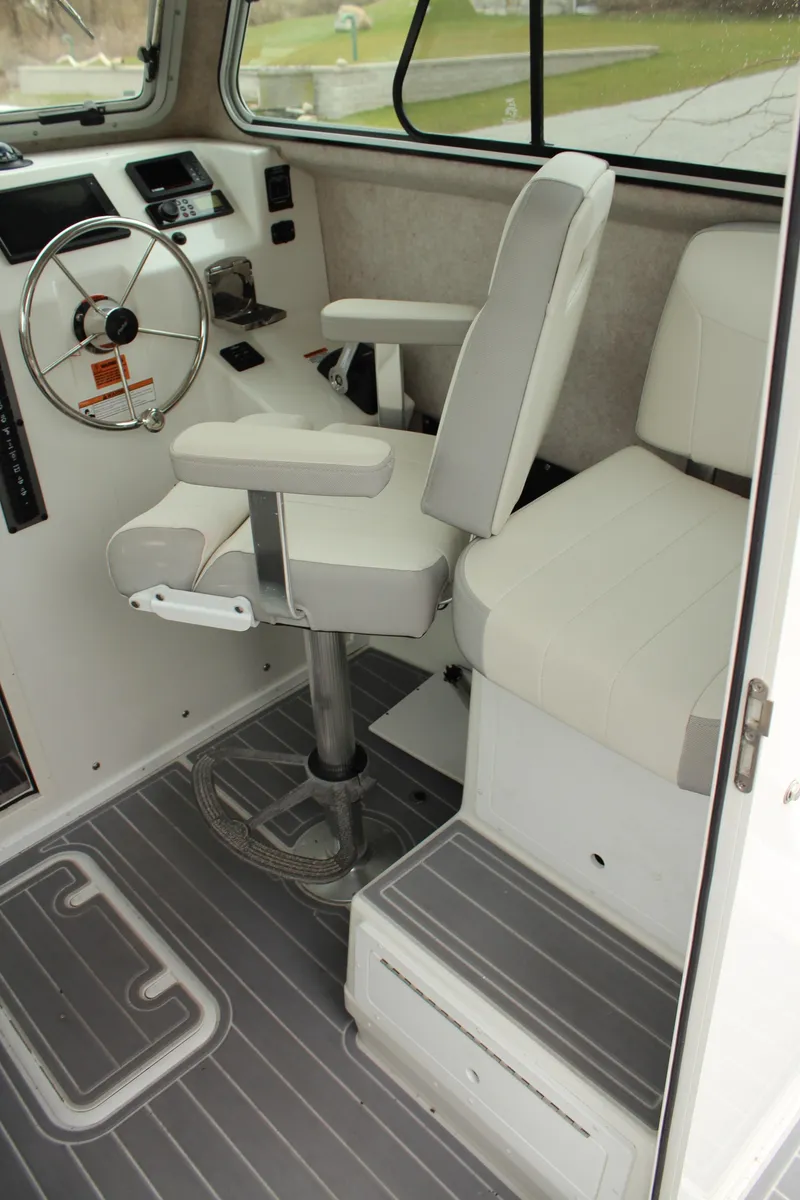 Slide: The Image of 2020 Parker 2520 XL Deep Vee Sport Cabin interior with helm and seating. - 31