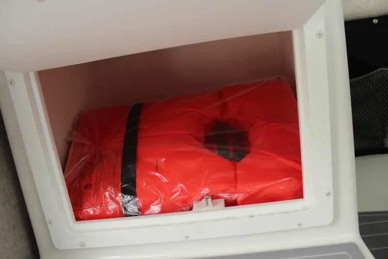 Slide: The Image of Life jacket stored in a compartment of a 2020 Parker 2520 XL Deep Vee Sport Cabin. - 37