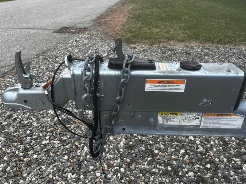 Slide: The Image of Trailer hitch with safety chains on gravel, Parker 2520 XL Deep Vee Sport Cabin, 2020 model. - 42