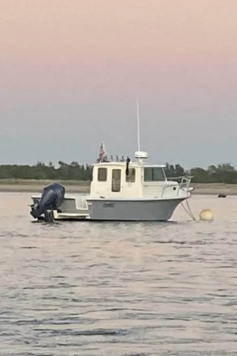 Slide: The Image of 2020 Parker 2520 XL Deep Vee Sport Cabin boat on calm water at sunset. - 44