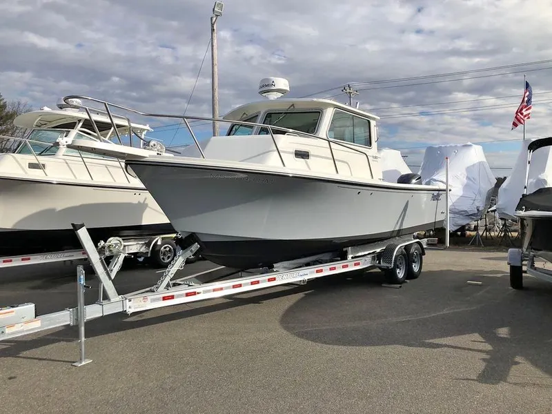Slide: The Image of 2020 Parker 2520 XL Deep Vee Sport Cabin boat on trailer, parked outdoors. - 7