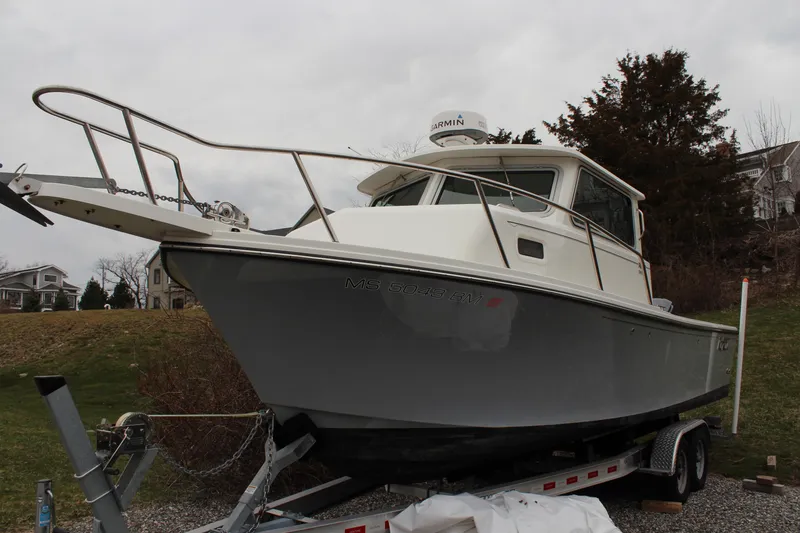 Slide: The Image of 2020 Parker 2520 XL Deep Vee Sport Cabin boat on trailer, parked outdoors. - 8