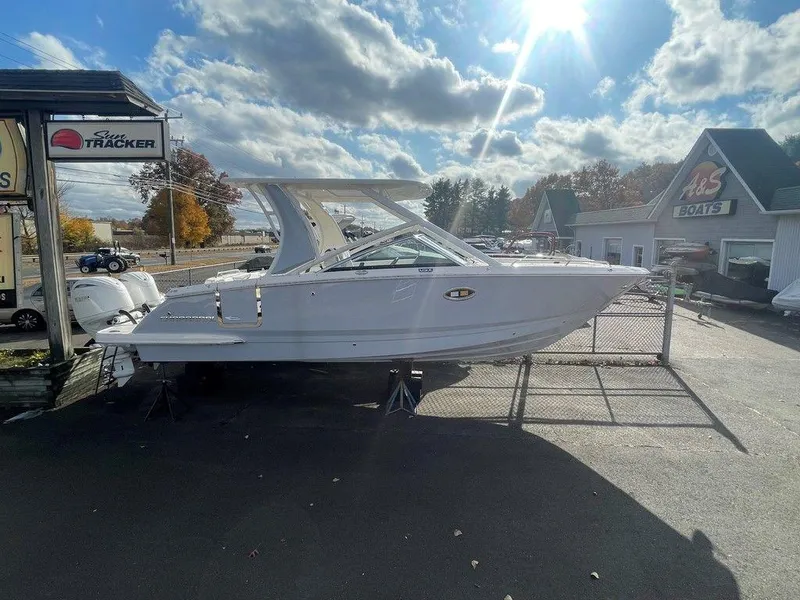 Slide: The Image of 2024 Chaparral 280 OSX boat displayed outdoors under a bright sky. - 10