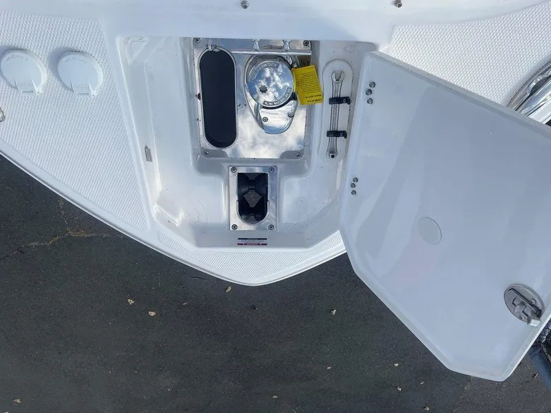 Slide: The Image of 2024 Chaparral 280 OSX boat anchor compartment with open hatch. - 13