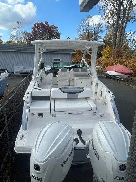 Slide: The Image of 2024 Chaparral 280 OSX boat with dual Yamaha engines, docked outdoors. - 16