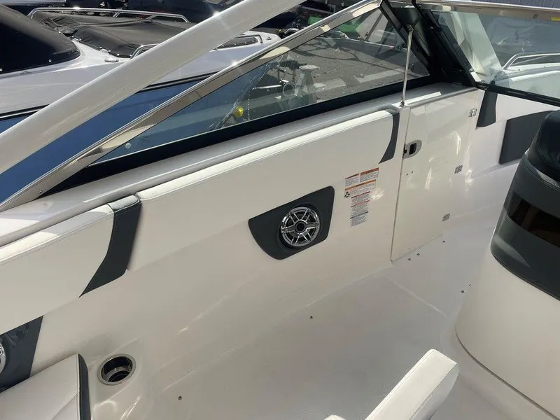 Slide: The Image of 2024 Chaparral 280 OSX boat interior with sleek white design and modern features. - 17