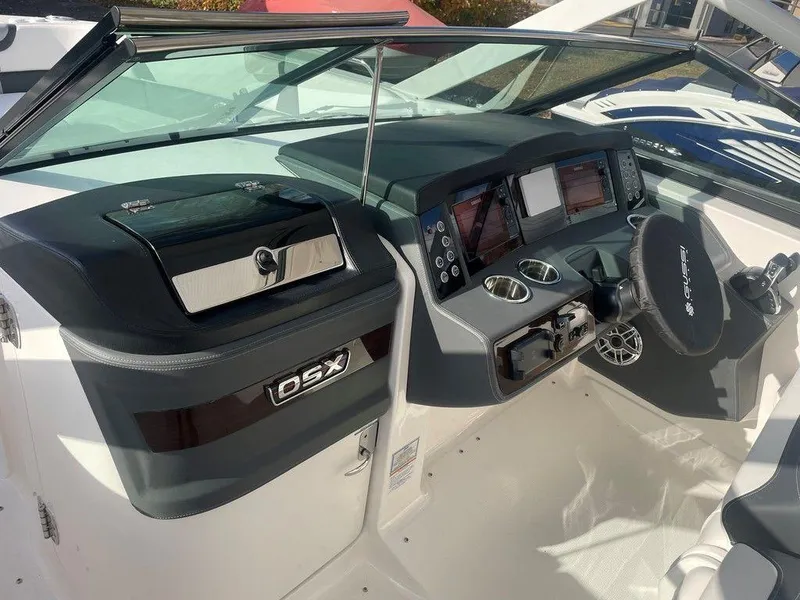 Slide: The Image of 2024 Chaparral 280 OSX boat dashboard with modern controls and sleek design. - 19
