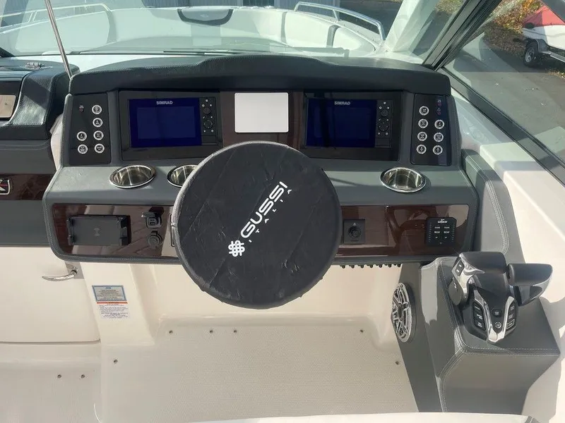 Slide: The Image of 2024 Chaparral 280 OSX boat dashboard with dual displays and Gussi steering wheel cover. - 20