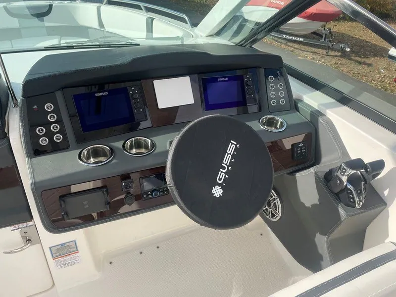 Slide: The Image of 2024 Chaparral 280 OSX dashboard with dual displays and Gussi steering wheel. - 21