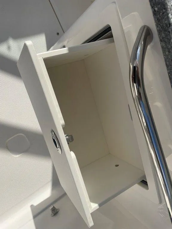 Slide: The Image of Open storage compartment on 2024 Chaparral 280 OSX boat. - 24