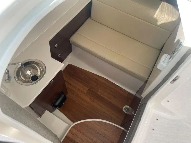Slide: The Image of 2024 Chaparral 280 OSX cabin interior with sink and seating area. - 26
