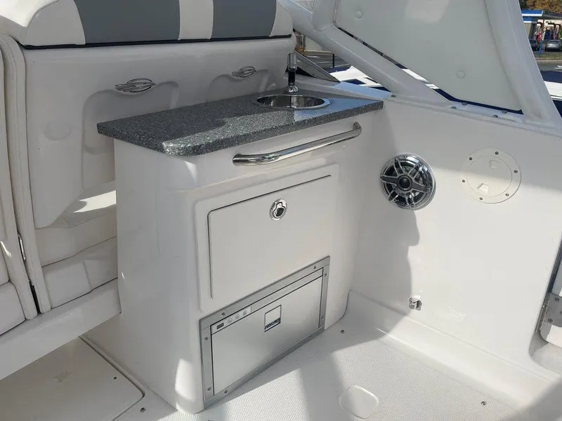 Slide: The Image of 2024 Chaparral 280 OSX boat interior with sink and storage area. - 31