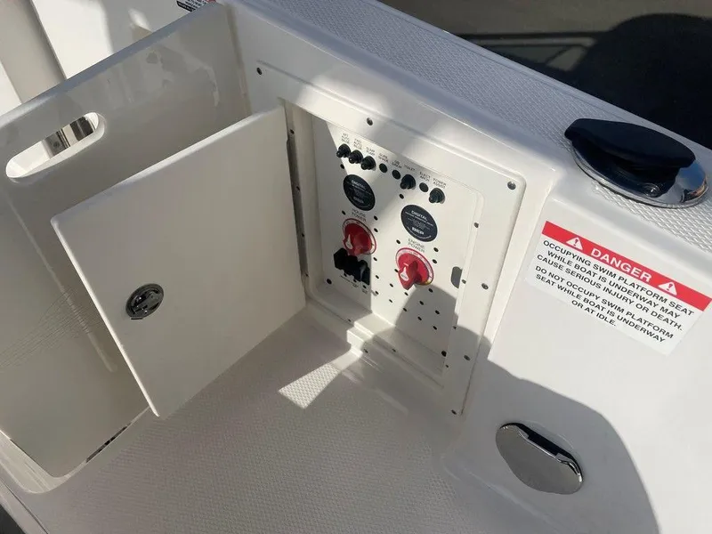 Slide: The Image of 2024 Chaparral 280 OSX boat control panel with open access door. - 32