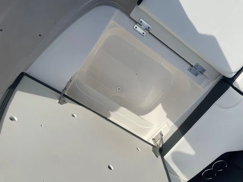 Slide: The Image of 2024 Chaparral 280 OSX boat storage compartment with open hatch. - 33