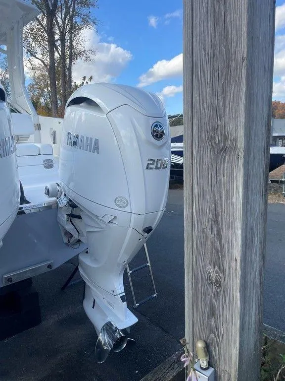 Slide: The Image of 2024 Chaparral 280 OSX with Yamaha outboard motor, parked outdoors. - 37