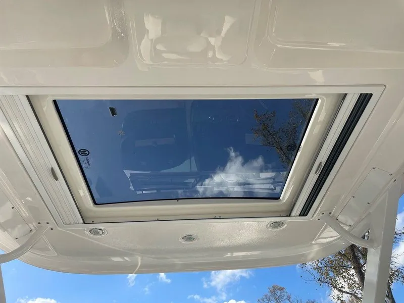 Slide: The Image of 2024 Chaparral 280 OSX boat sunroof with clear sky reflection. - 38