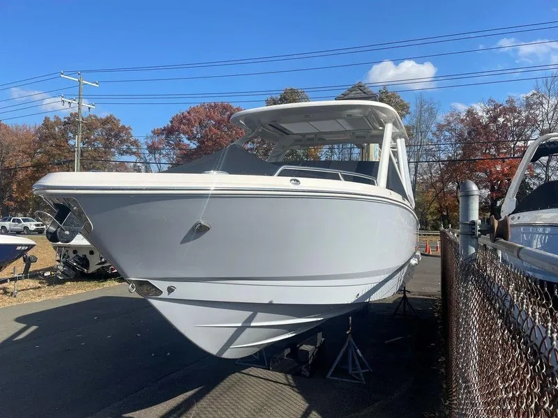 Slide: The Image of 2024 Chaparral 280 OSX boat displayed outdoors on a sunny day. - 4