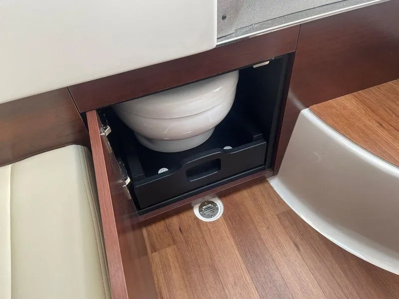 Slide: The Image of 2024 Chaparral 280 OSX boat interior with hidden toilet compartment. - 44