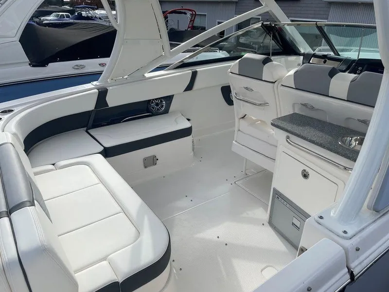Slide: The Image of 2024 Chaparral 280 OSX boat interior with white seating and modern design. - 47
