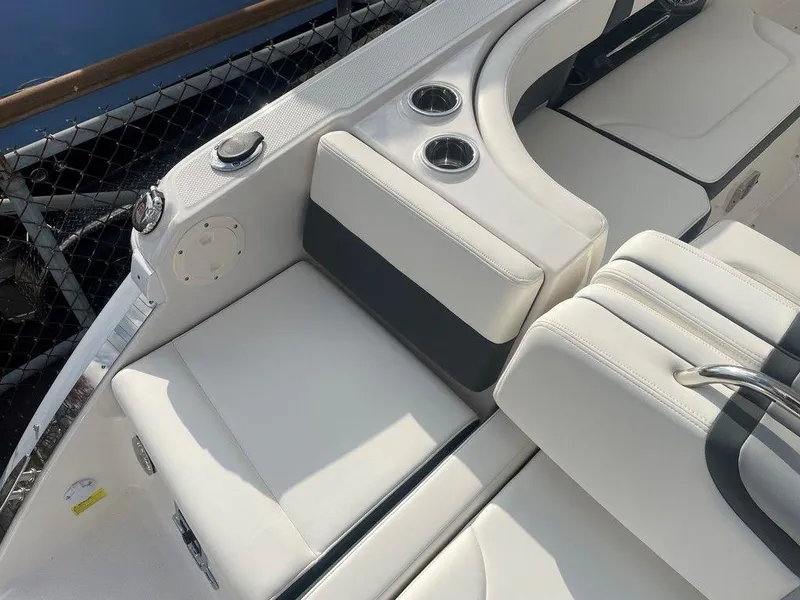Slide: The Image of 2024 Chaparral 280 OSX boat interior with white seating and cup holders. - 49