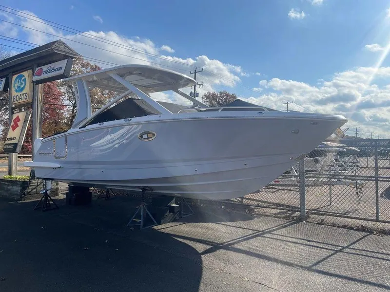 Slide: The Image of 2024 Chaparral 280 OSX boat displayed outdoors on a sunny day. - 5