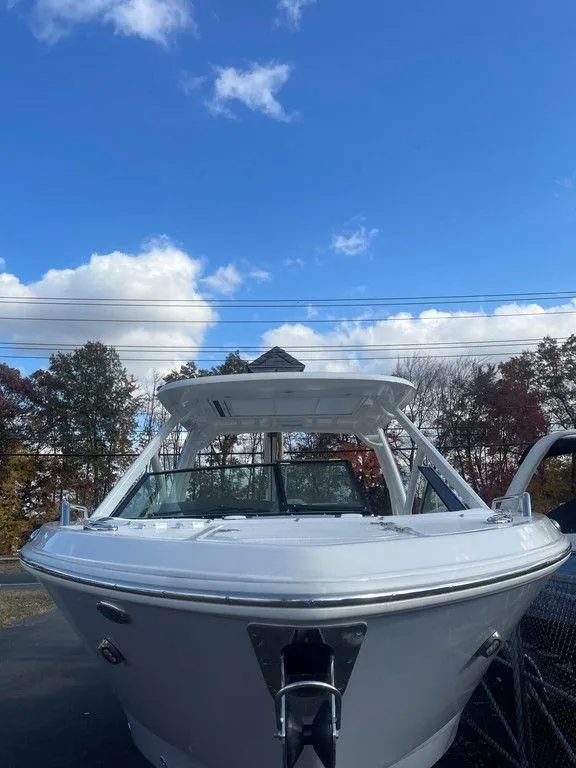 Slide: The Image of 2024 Chaparral 280 OSX boat under a clear blue sky. - 6