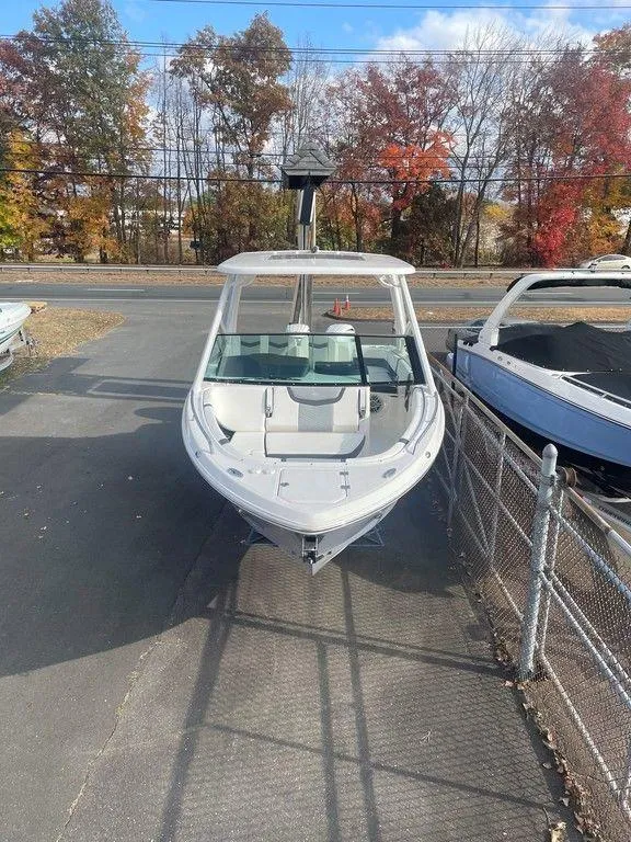 Slide: The Image of 2024 Chaparral 280 OSX boat in a parking lot with autumn trees in the background. - 7