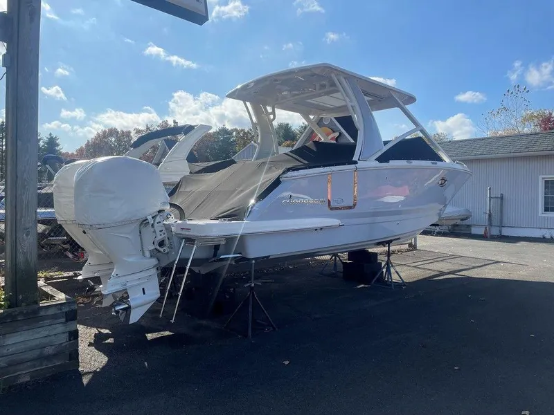 Slide: The Image of 2024 Chaparral 280 OSX boat on display outdoors under a clear sky. - 9