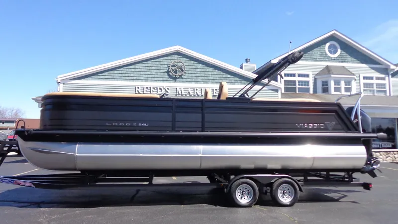 The Image of 2024 Viaggio Lago Z24U pontoon boat on trailer outside Reeds Marine. - 0