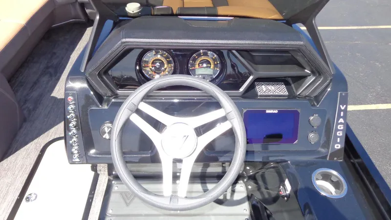 Slide: The Image of 2024 Viaggio Lago Z24U boat dashboard with steering wheel and instrument panel. - 11