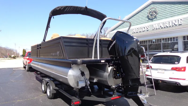 Slide: The Image of 2024 Viaggio Lago Z24U pontoon boat on trailer outside dealership. - 2