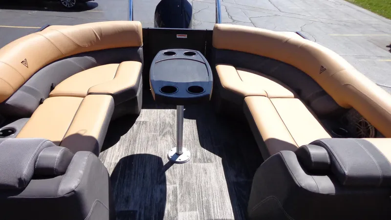 Slide: The Image of 2024 Viaggio Lago Z24U boat interior with tan and gray seating, central table, and cup holders. - 26