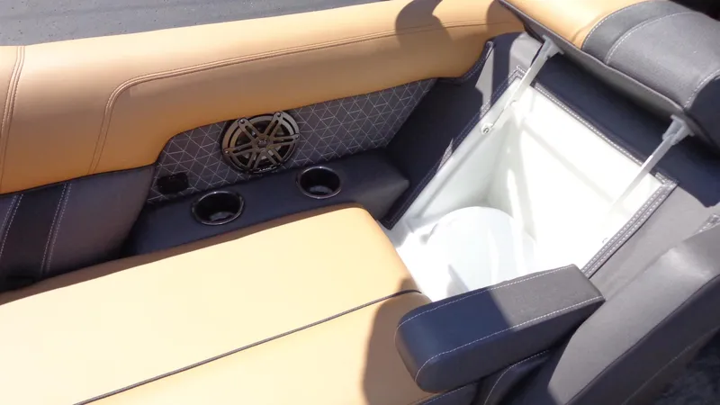 Slide: The Image of 2024 Viaggio Lago Z24U boat interior with tan and black seating, cup holders, and storage compartment. - 27