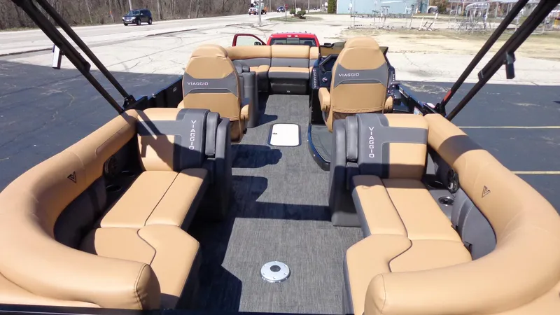 Slide: The Image of 2024 Viaggio Lago Z24U pontoon boat with tan and gray seating. - 5