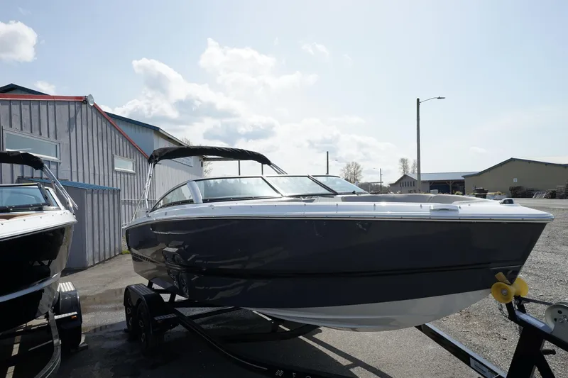 The Image of 2023 Four Winns H1 boat on trailer in outdoor storage area. - 1