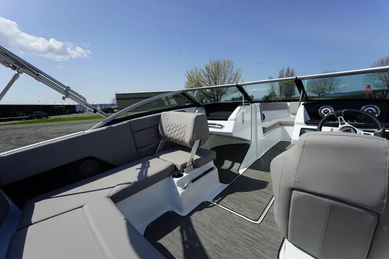 Slide: The Image of 2023 Four Winns H1 boat interior with modern seating and dashboard. - 14