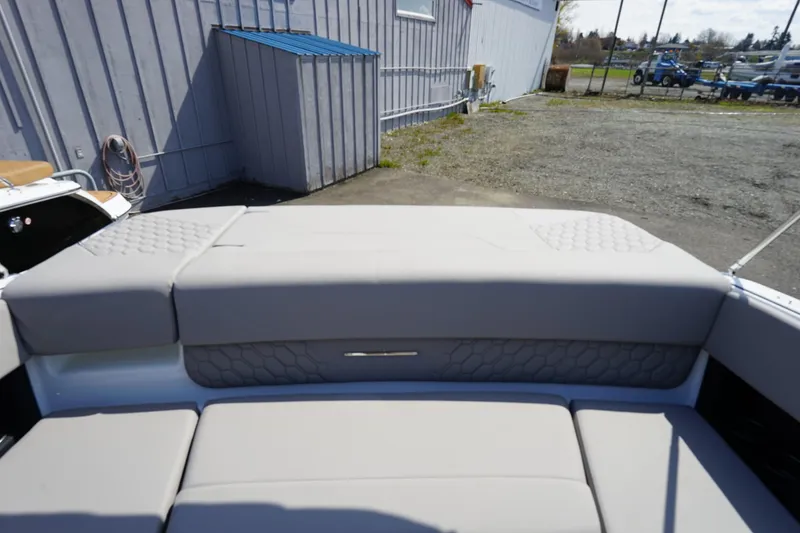 Slide: The Image of 2023 Four Winns H1 boat with beige cushioned seating and quilted backrest. - 17